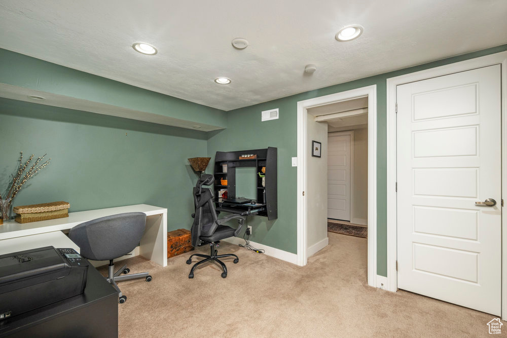 Carpeted office with baseboards and recessed lighting