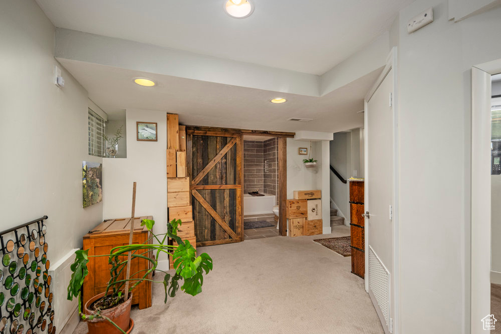 Interior space with recessed lighting, carpet, and stairway