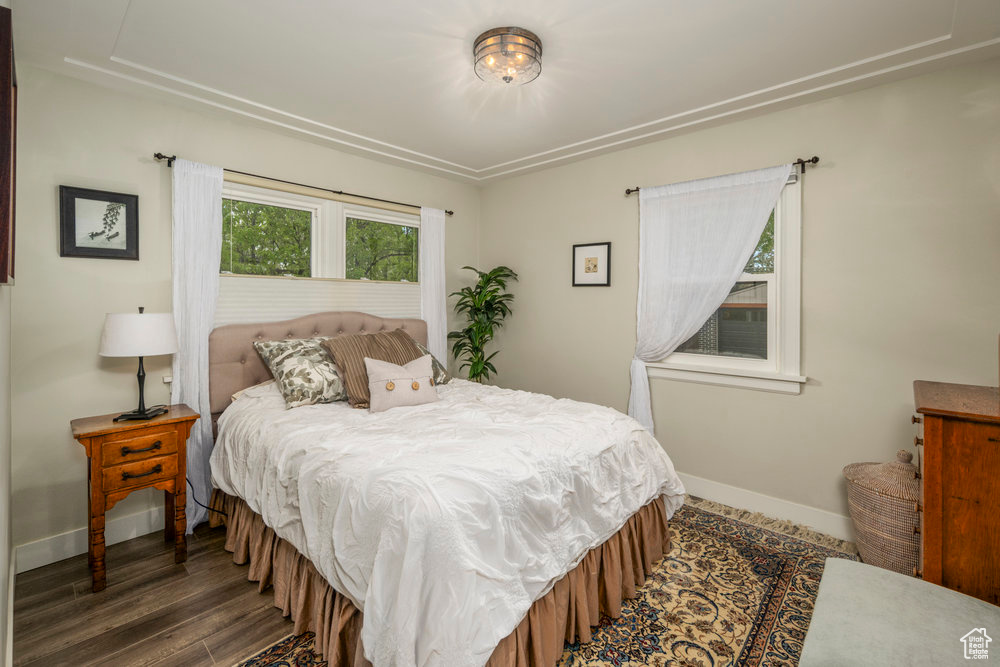 Bedroom with wood finished floors and baseboards