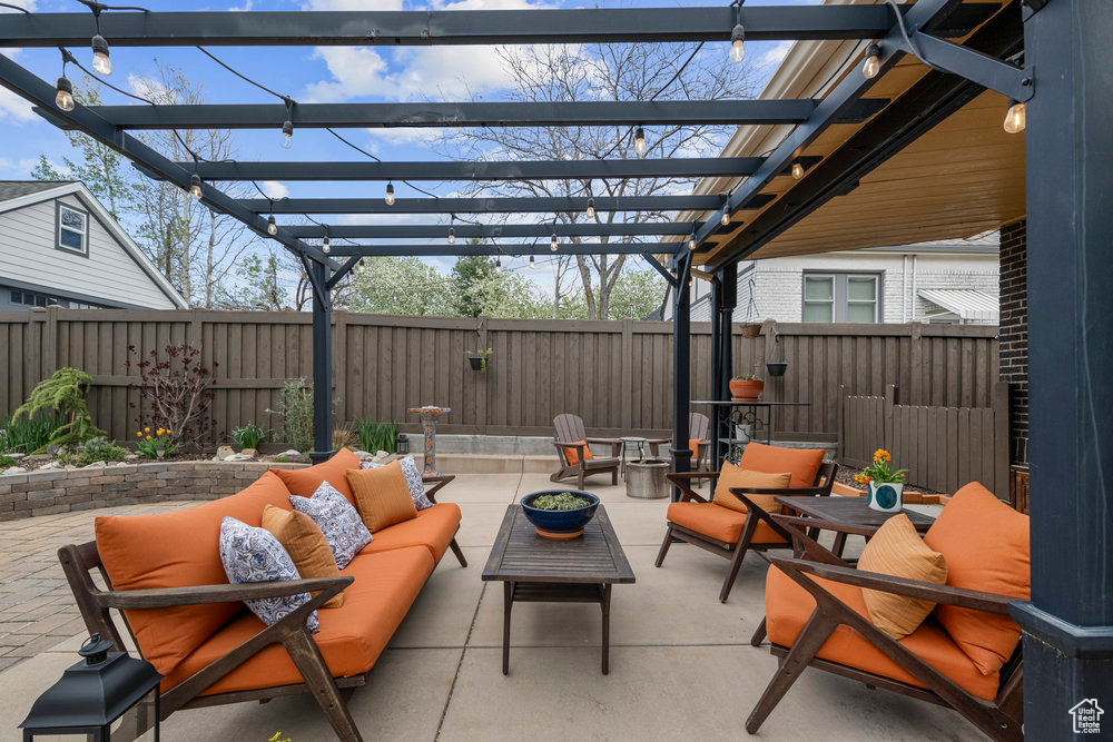 View of patio featuring a fenced backyard, outdoor lounge area, and a pergola