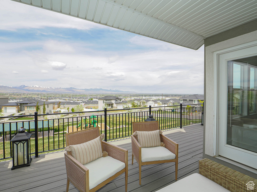 Wooden deck featuring a residential view and a mountain view
