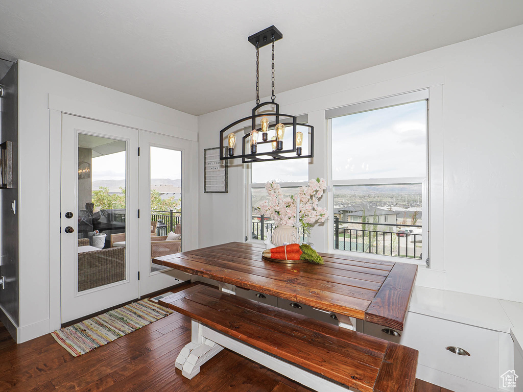 Dining space featuring wood finished floors and a chandelier