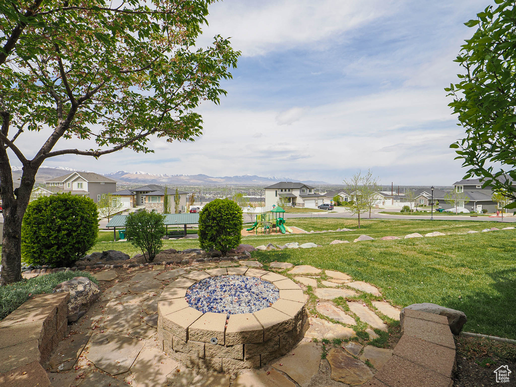 View of patio featuring a residential view, a playground, and a mountain view
