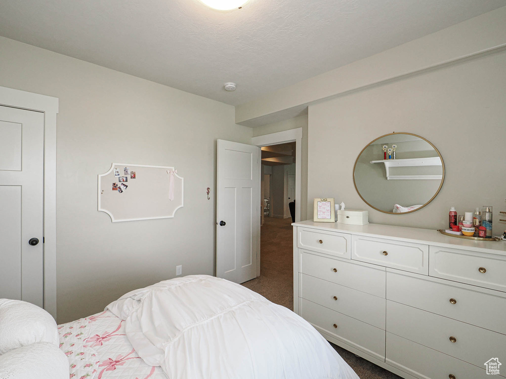 Bedroom featuring dark colored carpet