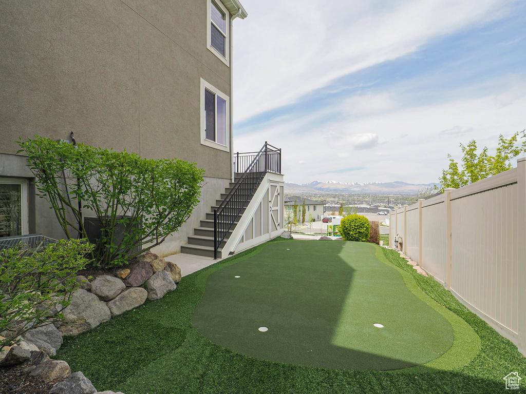 View of yard with stairway, fence, and a mountain view
