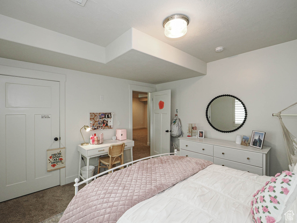 Bedroom featuring carpet floors and baseboards