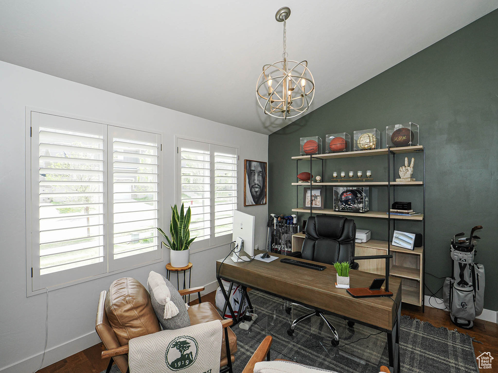 Office area featuring vaulted ceiling, wood finished floors, a chandelier, and baseboards