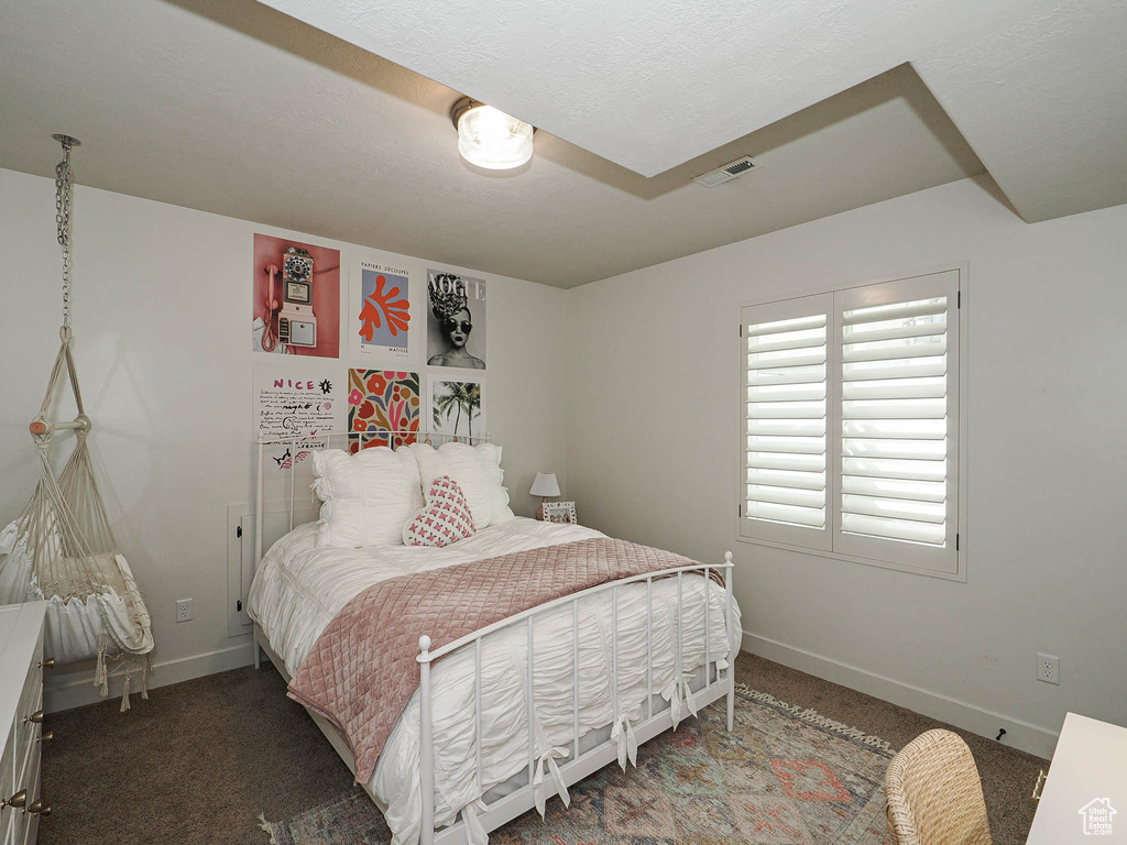 Bedroom with visible vents, carpet flooring, and baseboards