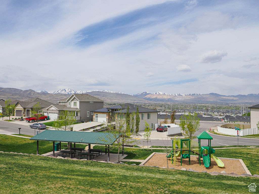 View of home's community featuring a residential view, a lawn, a mountain view, and playground community