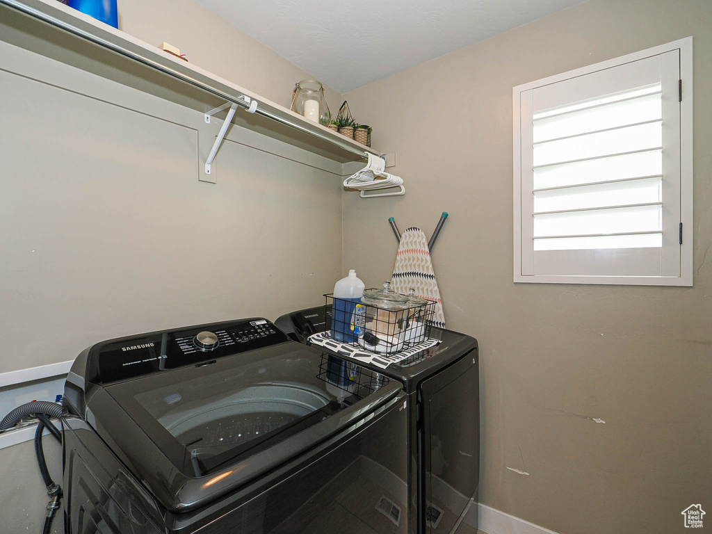 Washroom featuring washer and dryer and laundry area