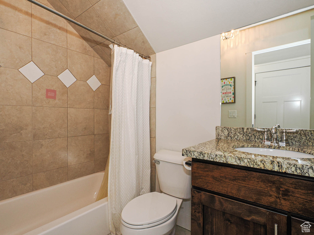 Full bath featuring toilet, vanity, and shower / bathtub combination with curtain