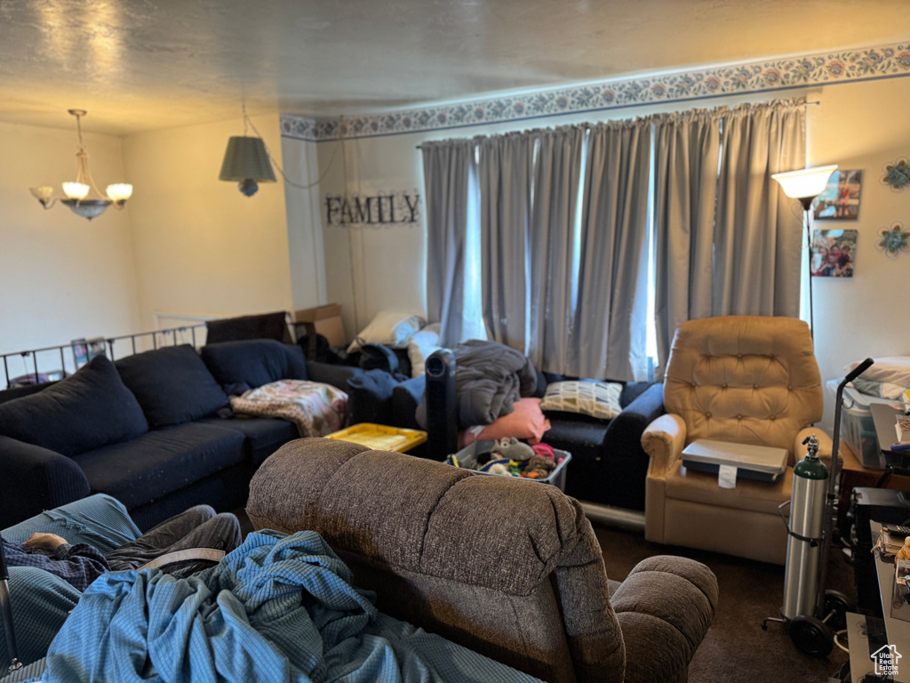 Carpeted living area featuring a chandelier