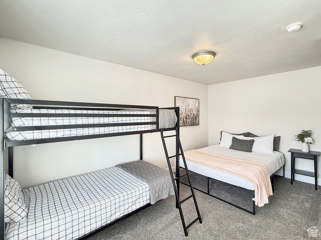 Carpeted bedroom with a textured ceiling