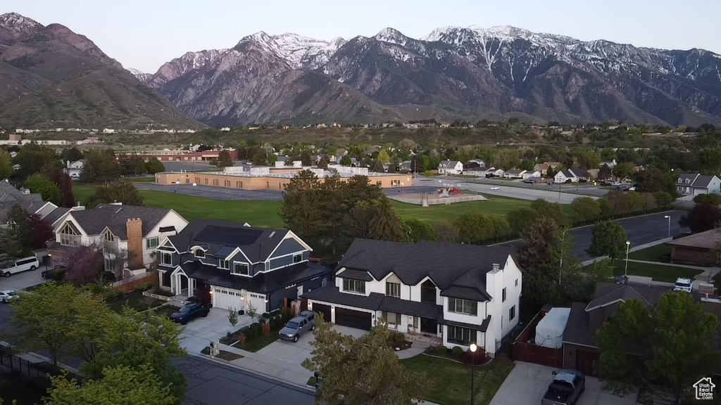 Aerial view of property's location with a mountainous background and nearby suburban area