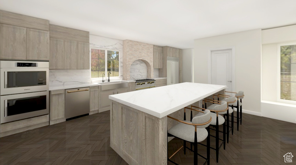 Kitchen with a center island, light countertops, a sink, dishwashing machine, and double wall oven