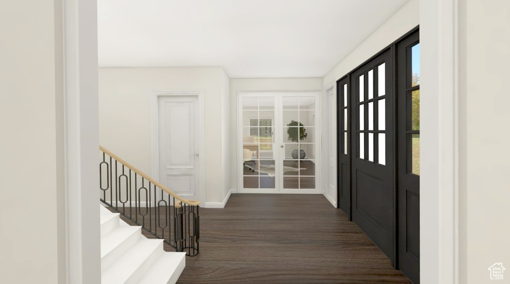 Doorway with baseboards, dark wood finished floors, and stairs
