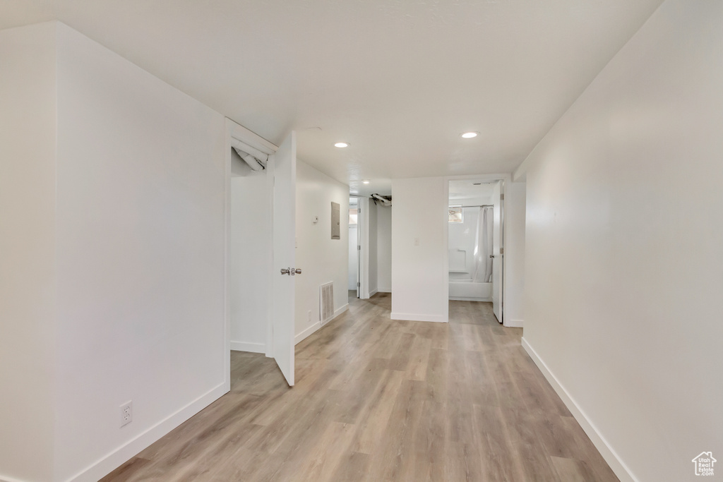 Interior space with baseboards, visible vents, light wood-style floors, and recessed lighting
