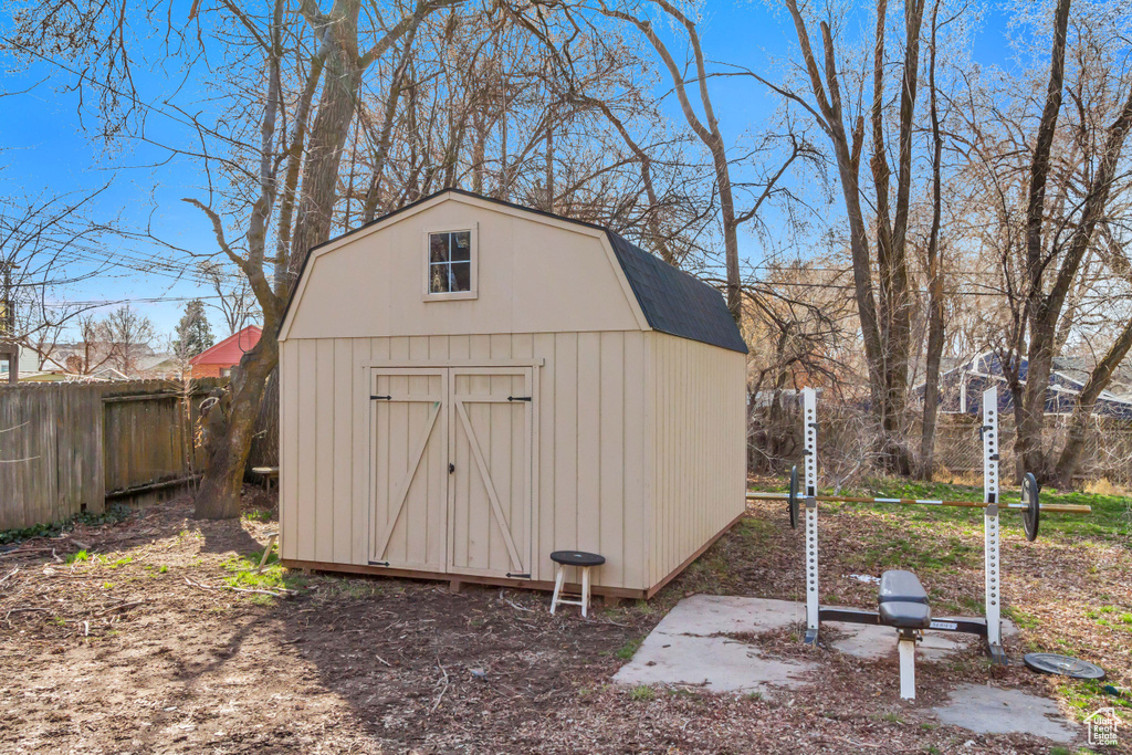 View of shed featuring fence