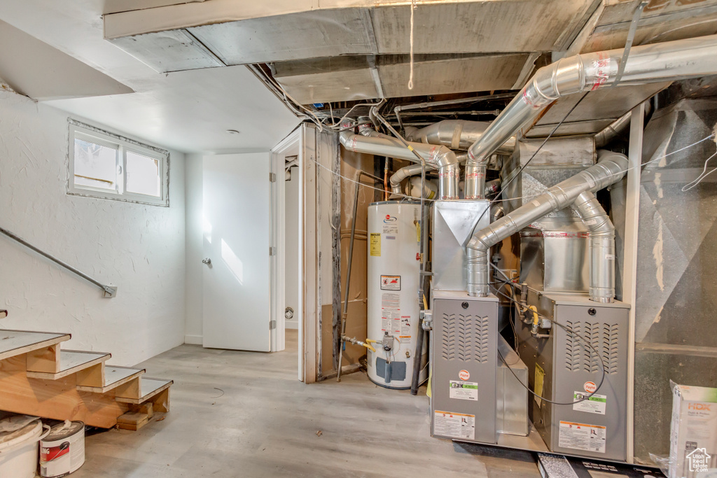 Below grade area featuring stairs and water heater