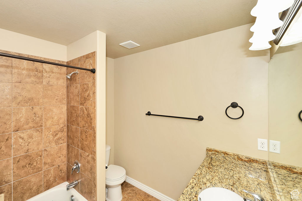 Full bathroom featuring  shower combination, toilet, visible vents, tile patterned flooring, and vanity