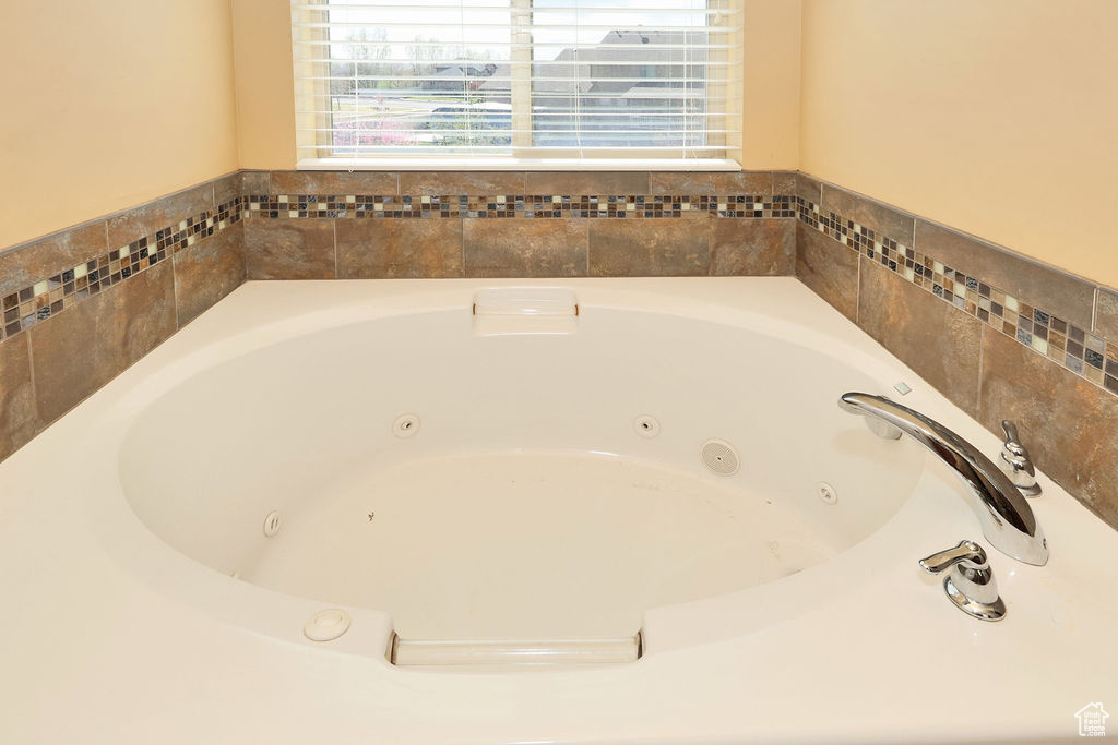 Full bath featuring a tub with jets
