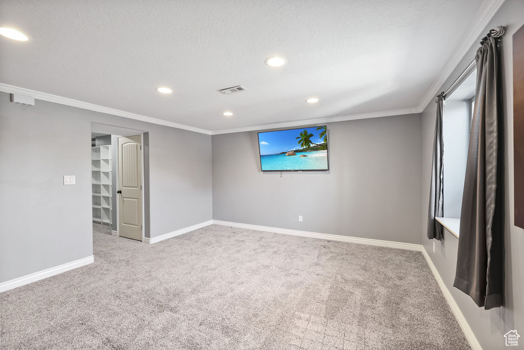 Unfurnished room with recessed lighting, carpet floors, visible vents, and crown molding