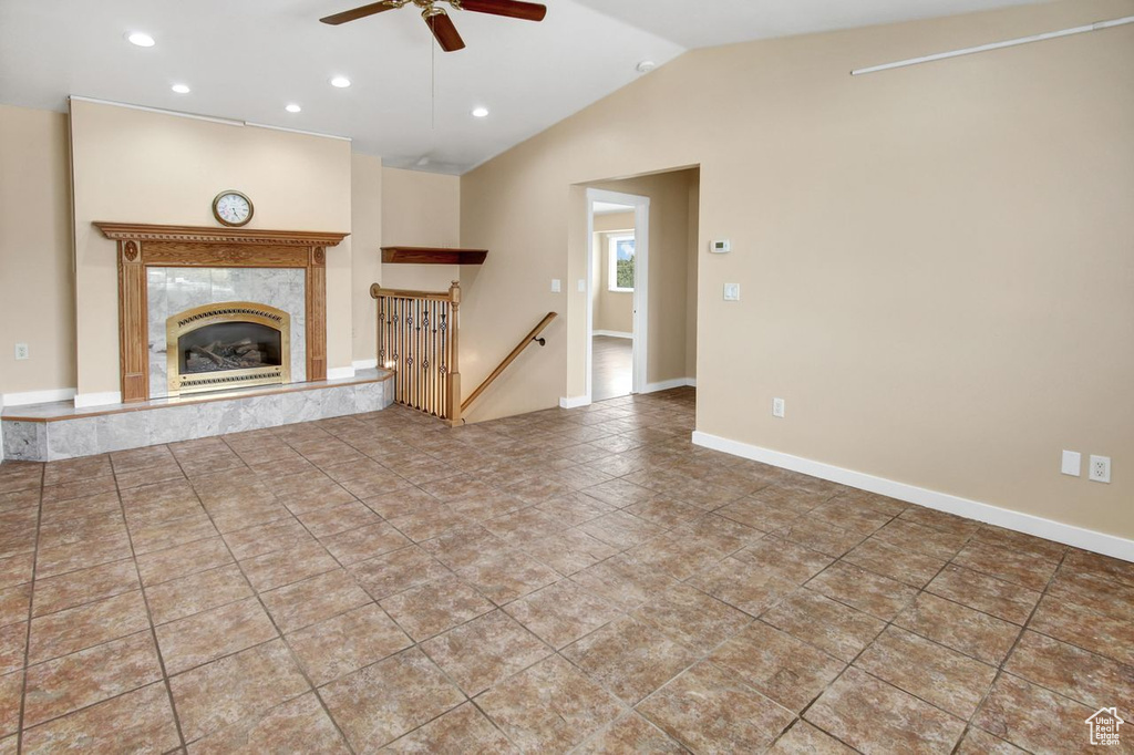 Unfurnished living room with recessed lighting, a fireplace, a ceiling fan, baseboards, and lofted ceiling