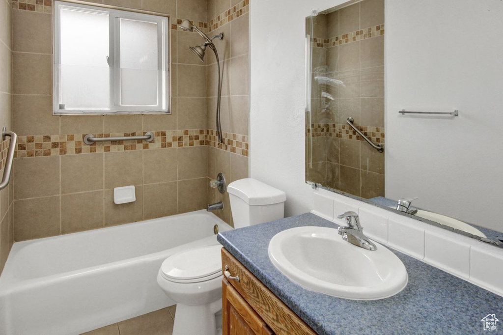 Bathroom featuring toilet, bathtub / shower combination, and vanity