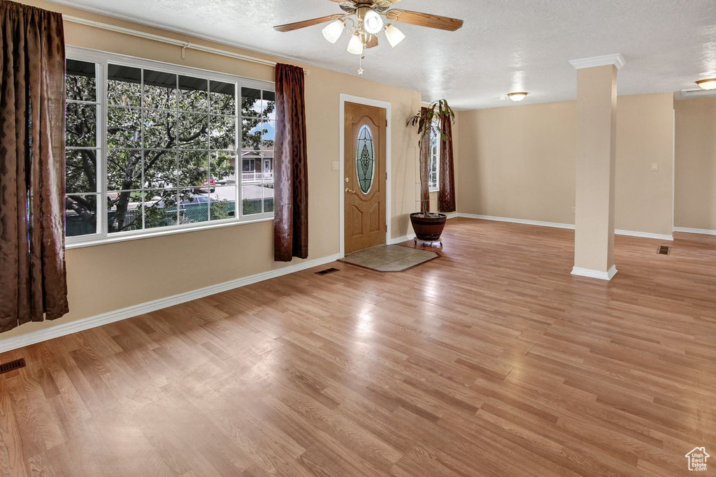 Entryway featuring baseboards, visible vents, wood finished floors, and a ceiling fan