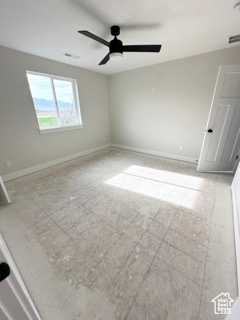 Spare room featuring ceiling fan and baseboards