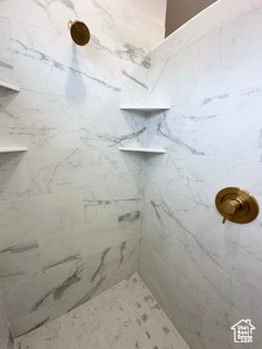 Bathroom with a marble finish shower