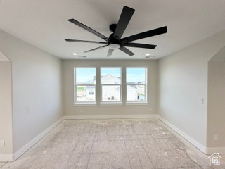 Empty room with a ceiling fan and baseboards