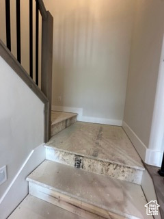Staircase featuring baseboards