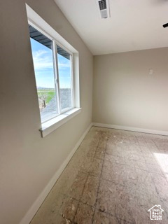 Spare room featuring visible vents and baseboards