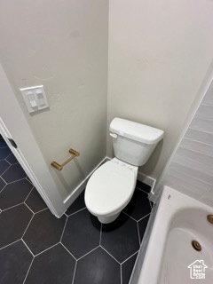 Bathroom featuring tile patterned floors and toilet