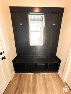 Mudroom featuring light wood-style flooring and baseboards