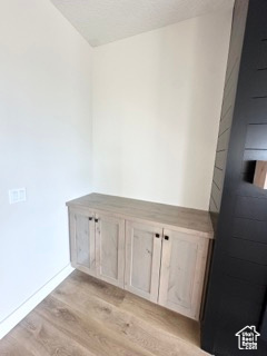 Interior space with baseboards and wood finished floors