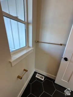Bathroom featuring tile patterned floors, visible vents, and baseboards
