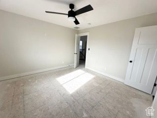Unfurnished bedroom featuring ceiling fan and baseboards