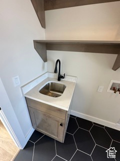 Laundry area featuring washer hookup, baseboards, laundry area, and a sink