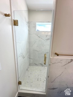 Full bathroom featuring a marble finish shower