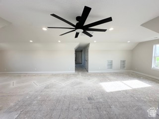 Unfurnished living room with lofted ceiling, recessed lighting, a ceiling fan, and baseboards