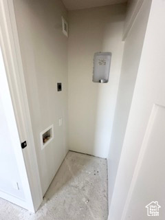 Clothes washing area featuring washer hookup and visible vents