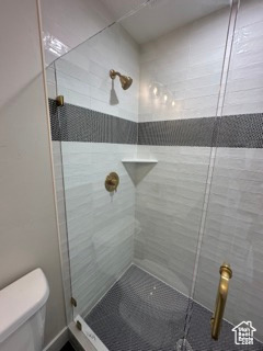 Full bath with toilet and a stall shower