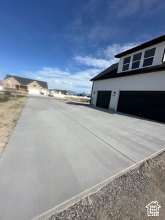 View of home's exterior with driveway and a garage