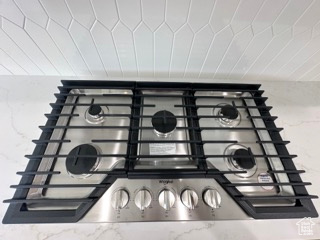 Interior details with stainless steel gas cooktop and stone countertops