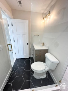 Bathroom featuring visible vents, toilet, tile patterned flooring, and a sink