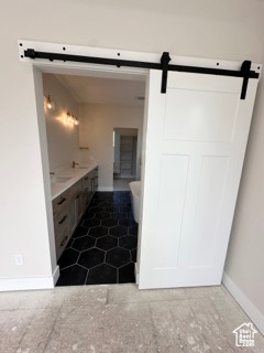Bathroom with vanity and baseboards