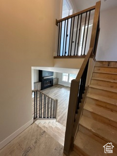 Stairway featuring hardwood / wood-style floors and baseboards