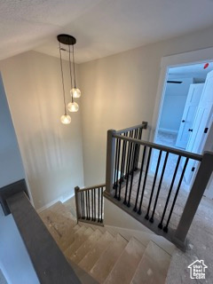 Stairway with baseboards and lofted ceiling